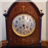 D52. A. Stowll electric clock with marquetry case. 